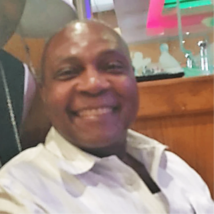 A man in a white shirt, smiling